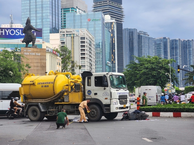 Xe máy bị hư hỏng nằm trước đầu xe bồn sau tai nạn.