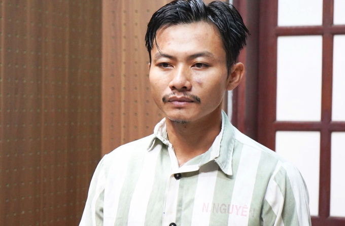 Lê Thanh Nhất Nguyên nghe tống đạt quyết định khởi tố, ngày 9/7. Ảnh: Thường Sơn